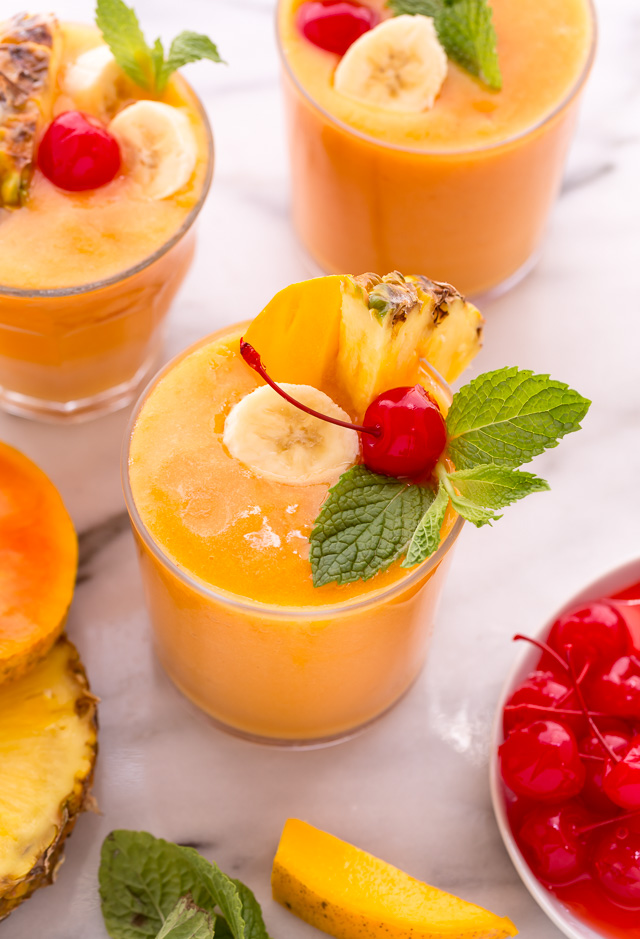 This refreshing tropical smoothie recipe is made with exotic fruit like mango, pineapple, and papaya! Ready in less than 5 minutes, this delicious and healthy treat is the perfect way to start your morning! Makes 2 smoothies, but can easily be double or tripled as needed! #tropicalsmoothie #fruitsmoothie #smoothies #smoothie #pineapplesmoothie #tropical