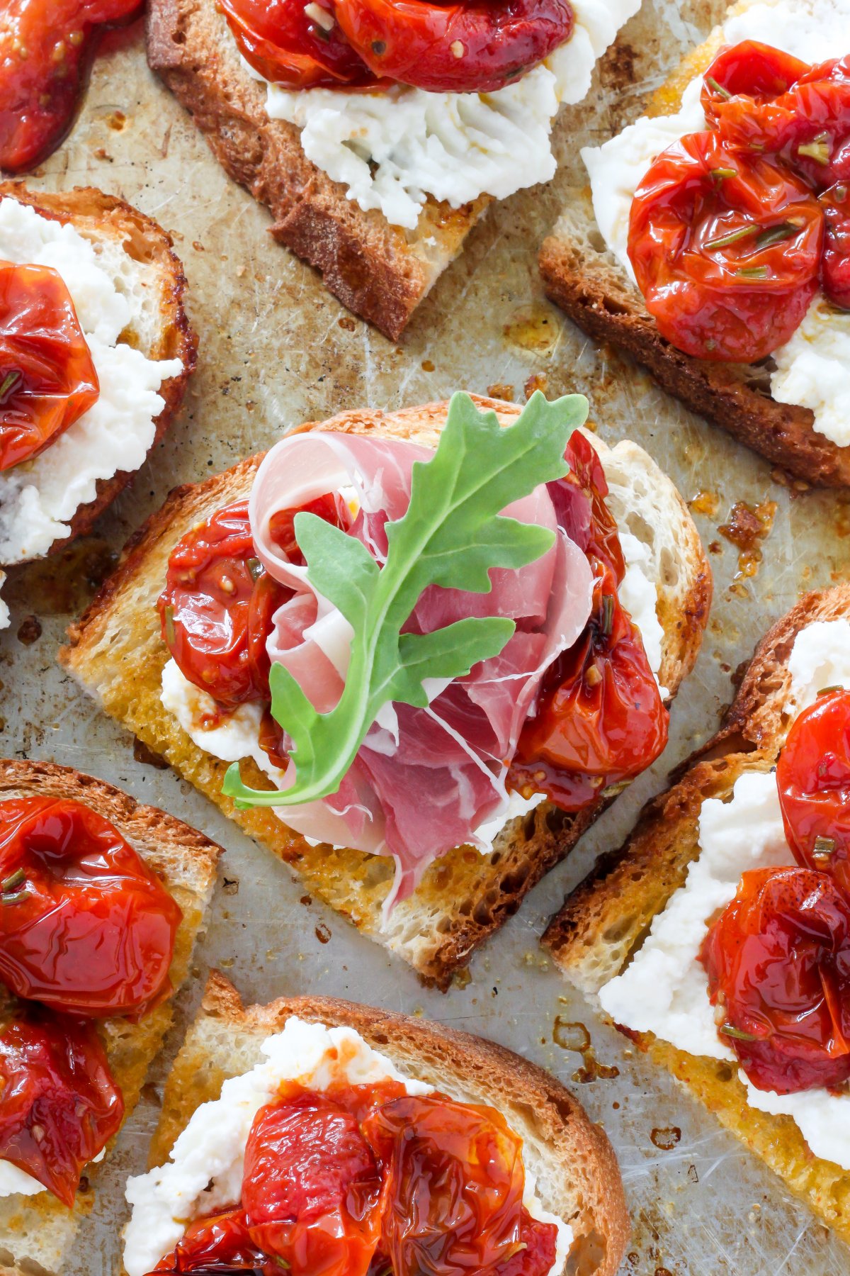 Bruschetta with Rosemary, Roasted Tomatoes, Ricotta, and Prosciutto
