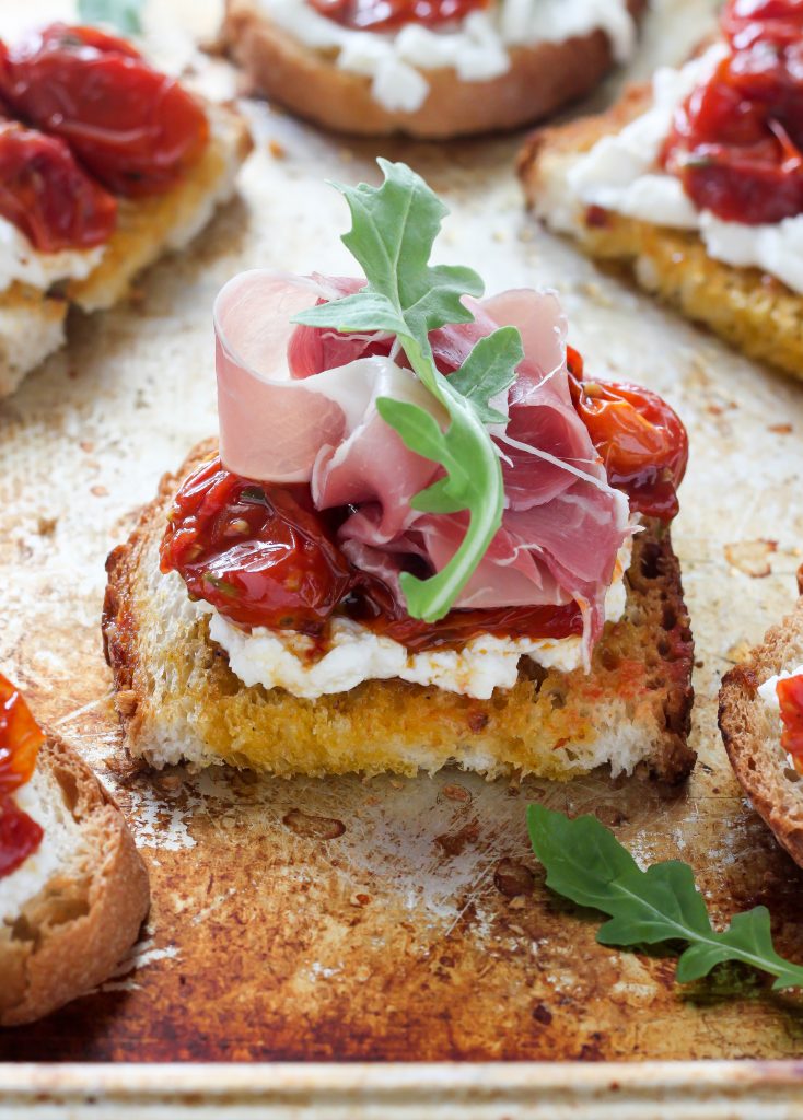 Bruschetta with Rosemary, Roasted Tomatoes, Ricotta, and Prosciutto