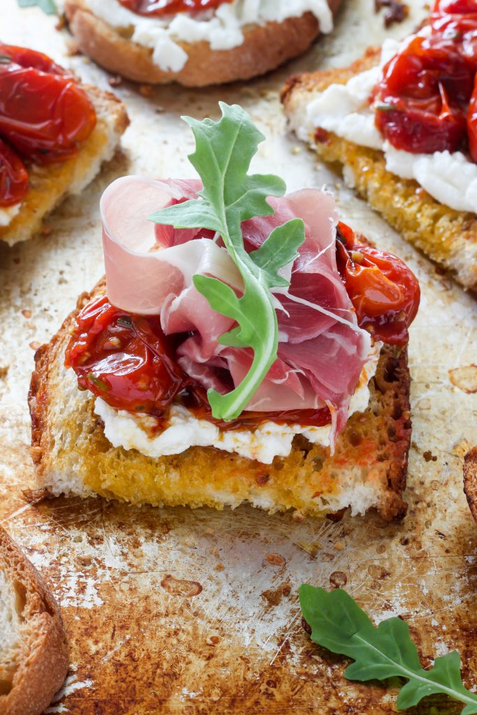 Bruschetta with Rosemary, Roasted Tomatoes, Ricotta, and Prosciutto