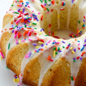 A supremely moist Vanilla Buttermilk Bundt Cake topped with a simple Vanilla Glaze and plenty of sprinkles!