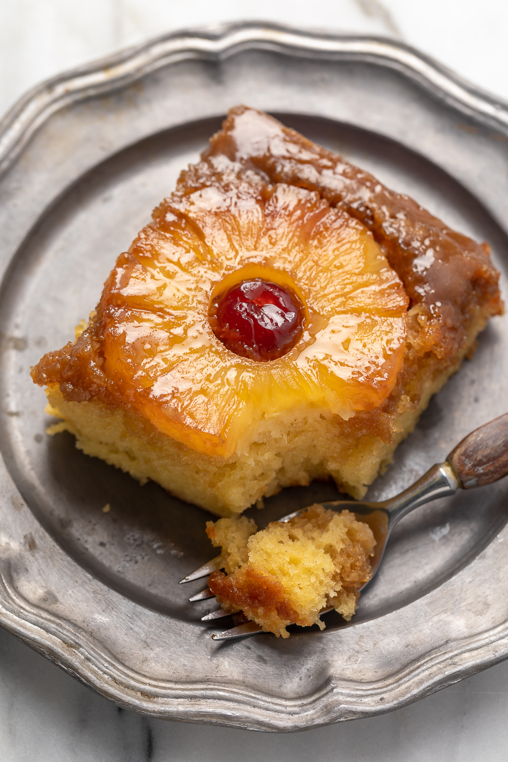 Pineapple Upside-Down Cake is sticky, sweet, and so delicious! This version serves a crowd and is easy enough to whip up on a weeknight! Delicious with a scoop of vanilla ice cream on top! 