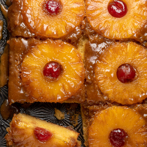 Pineapple Upside-Down Cake is sticky, sweet, and so delicious! This version serves a crowd and is easy enough to whip up on a weeknight! Delicious with a scoop of vanilla ice cream on top! 