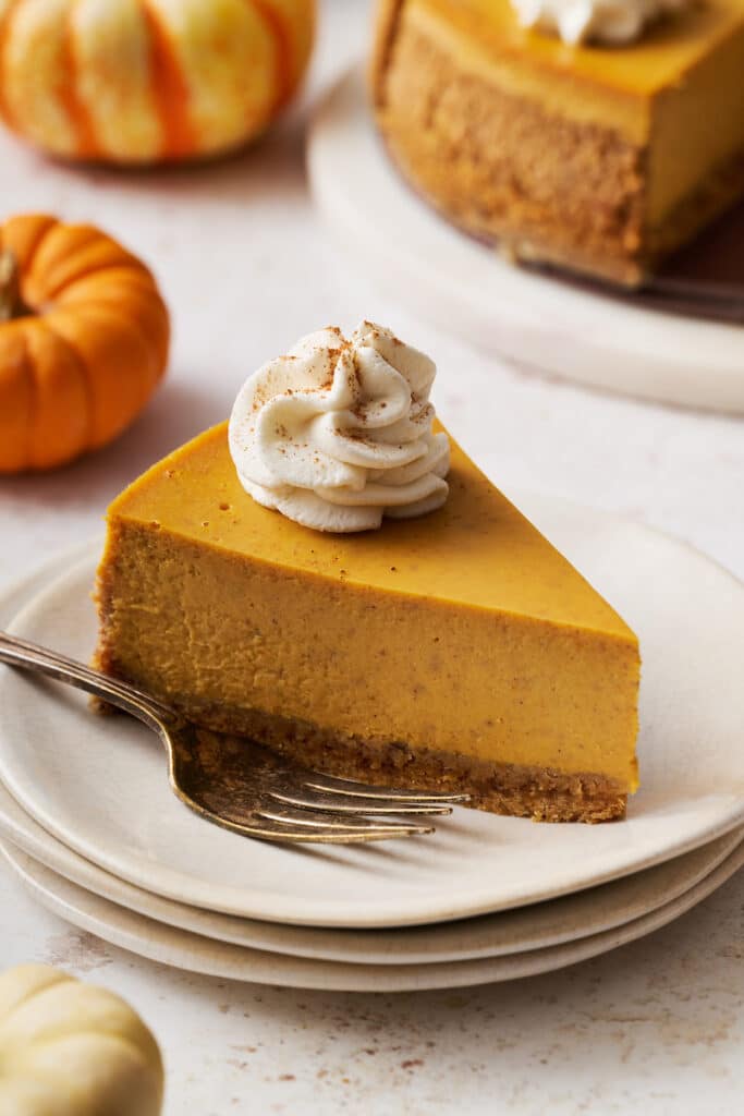 Slice of pumpkin cheese on plate with fork.