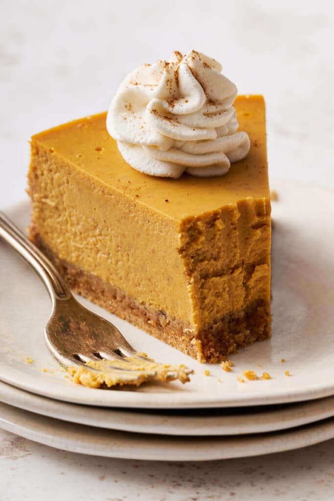 Pumpkin cheesecake topped with whipped cream.