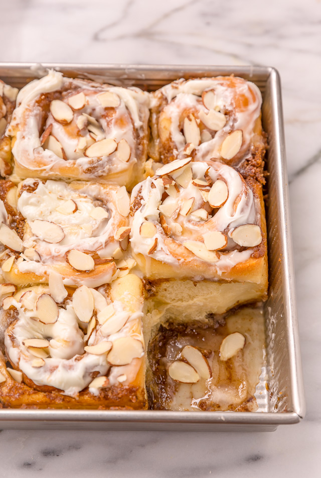 Triple Almond Cinnamon Rolls are the ultimate breakfast treat! This indulgent recipe features soft and fluffy yeasted buns that are filled with brown sugar cinnamon filling and topped with a sticky sweet glaze and slivered almonds! This homemade almond cinnamon roll recipe is a MUST for all of the almond lovers out there!