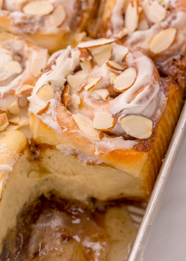 Triple Almond Cinnamon Rolls are the ultimate breakfast treat! This indulgent recipe features soft and fluffy yeasted buns that are filled with brown sugar cinnamon filling and topped with a sticky sweet glaze and slivered almonds! This homemade almond cinnamon roll recipe is a MUST for all of the almond lovers out there!