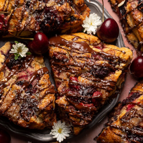 Golden brown, loaded with juicy cherries, and drizzled with dark chocolate, these Chocolate Covered Cherry Scones are a total showstopper! Perfect for breakfast or brunch and so good with a cup of coffee! For an extra chocolate kick, add a 1/2 cup of mini chocolate chips!