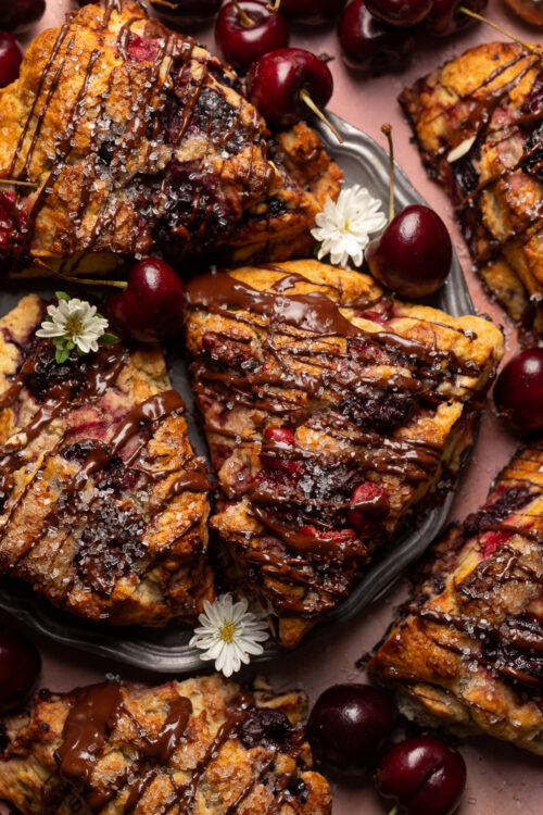 Golden brown, loaded with juicy cherries, and drizzled with dark chocolate, these Chocolate Covered Cherry Scones are a total showstopper! Perfect for breakfast or brunch and so good with a cup of coffee! For an extra chocolate kick, add a 1/2 cup of mini chocolate chips!