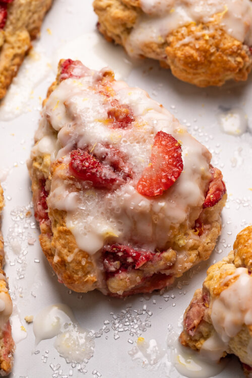 Fresh Strawberry Scones with Lemon Glaze are flaky and loaded with juicy strawberries! This is an easy breakfast the whole family will love! So good with a cup of tea or coffee!