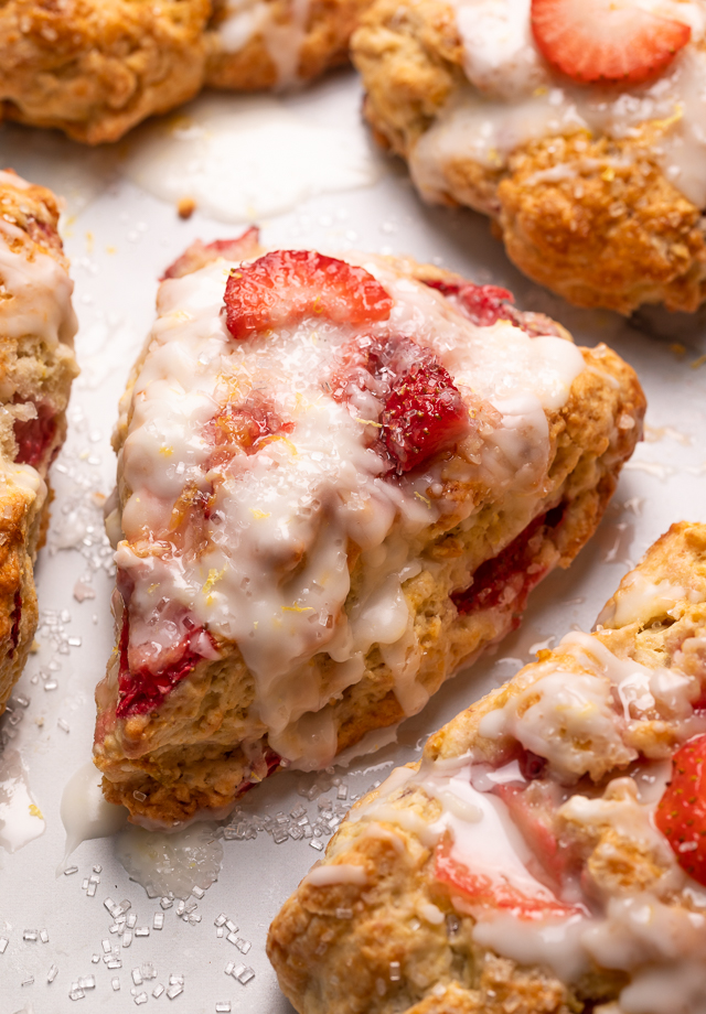 Fresh Strawberry Scones with Lemon Glaze are flaky and loaded with juicy strawberries! This is an easy breakfast the whole family will love! So good with a cup of tea or coffee!