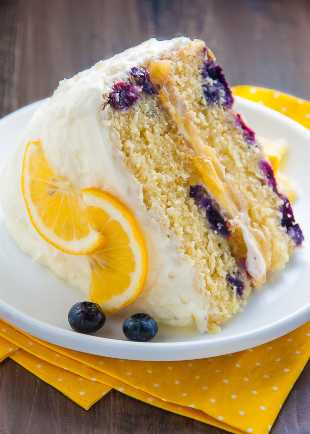Supremely moist and flavorful Lemon Blueberry Cake slathered with homemade Lemon Frosting. This is the ULTIMATE Lemon Blueberry Cake!