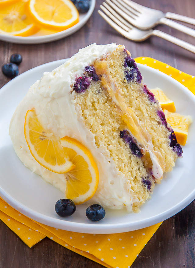 Supremely moist and flavorful Lemon Blueberry Cake slathered with homemade Lemon Frosting. This is the ULTIMATE Lemon Blueberry Cake!