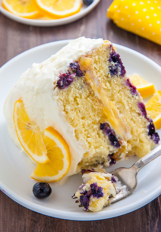 Supremely moist and flavorful Lemon Blueberry Cake slathered with homemade Lemon Frosting. This is the ULTIMATE Lemon Blueberry Cake!