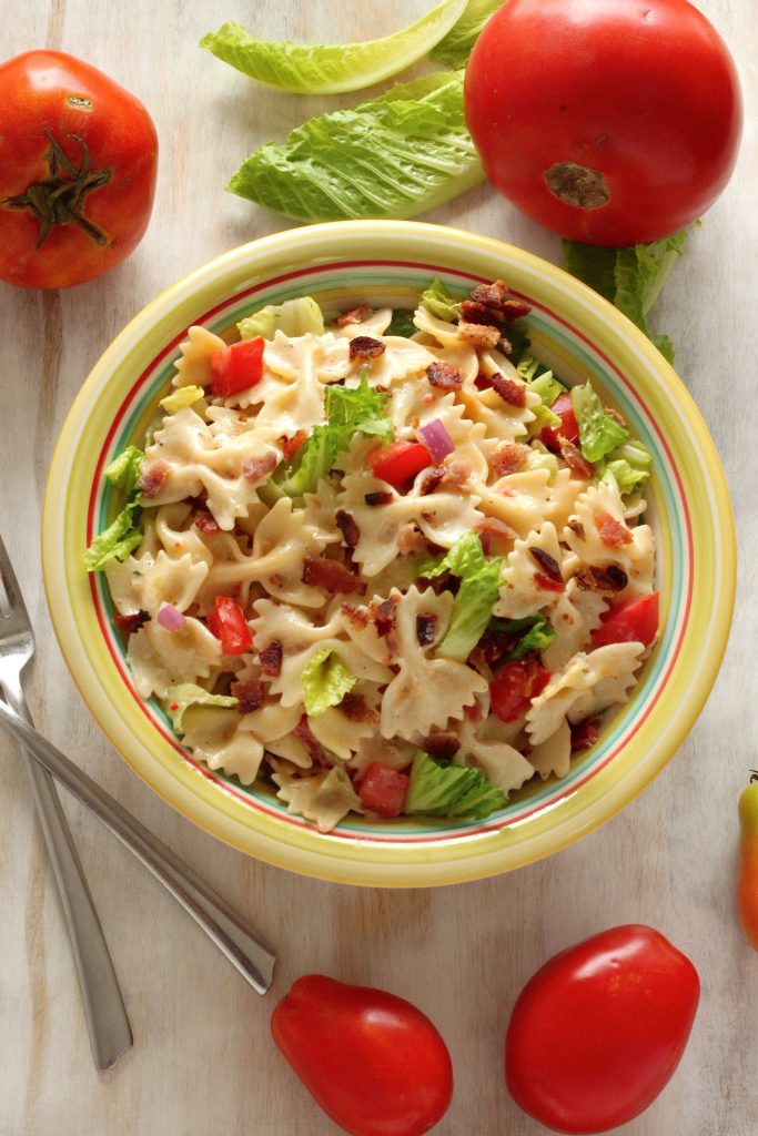 This 20-Minute BLT Easy Pasta Salad is fresh, fast, SUPER satisfying! This simple bow tie pasta salad is LOADED with bacon, lettuce, and tomato!!! And then it's dressed in a slightly creamy - and totally addicting - Zesty Italian dressing. 