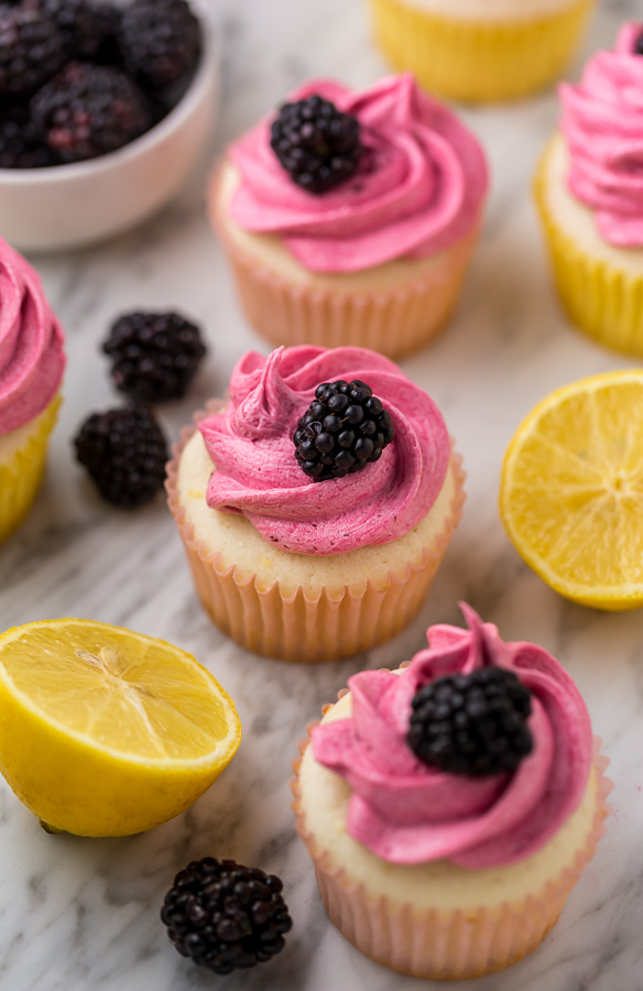 Fluffy Lemon Cupcakes are topped with BLACKBERRY Buttercream! These Lemon Blackberry Cupcakes are so pretty and always a showstopper. Their refreshing flavor makes them perfect for Spring and Summer celebrations! 