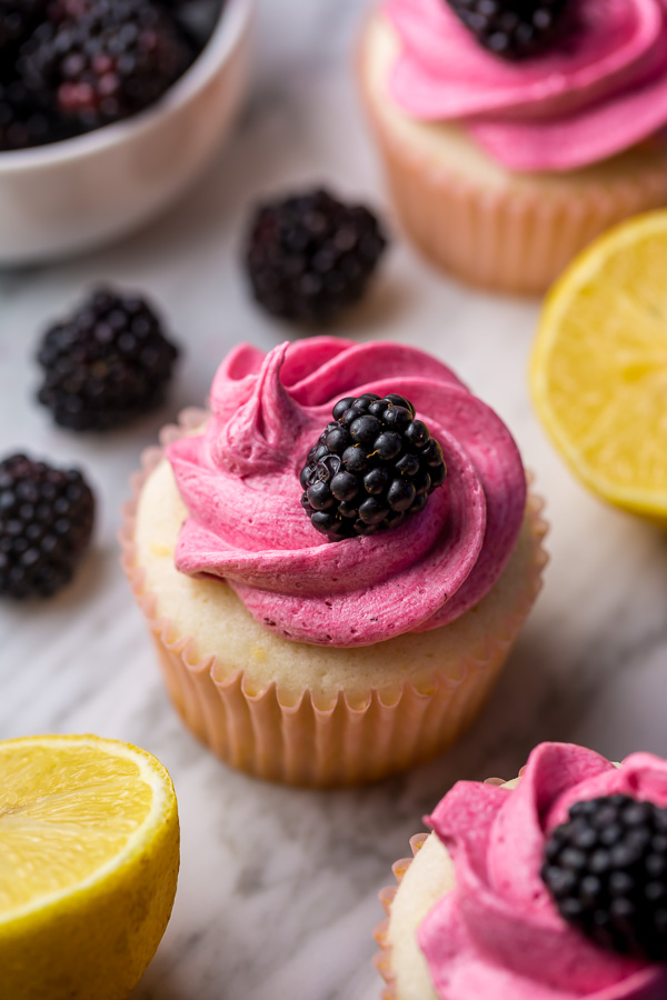 Fluffy Lemon Cupcakes are topped with BLACKBERRY Buttercream! These Lemon Blackberry Cupcakes are so pretty and always a showstopper. Their refreshing flavor makes them perfect for Spring and Summer celebrations! 