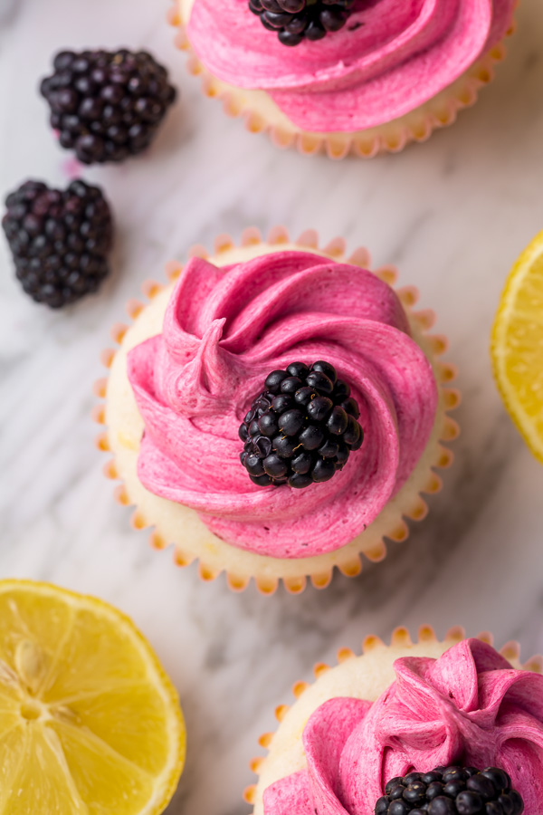 Fluffy Lemon Cupcakes are topped with BLACKBERRY Buttercream! These Lemon Blackberry Cupcakes are so pretty and always a showstopper. Their refreshing flavor makes them perfect for Spring and Summer celebrations! 