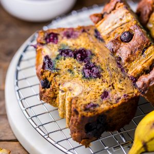 HOLY YUM! This Healthy Blueberry Banana Bread is moist, flavorful, and so delicious. Can't believe it's made with good-for-you ingredients.