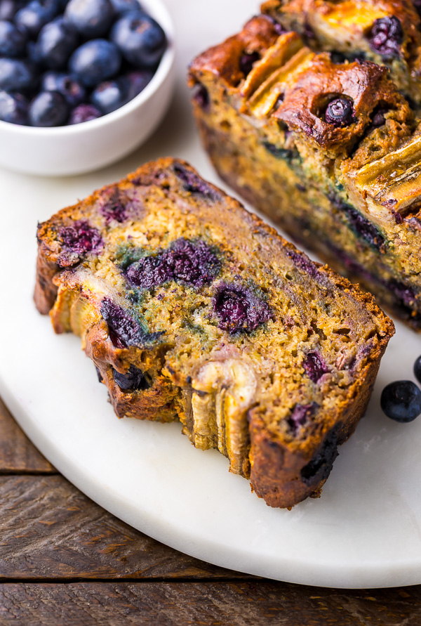 Healthy blueberry banana bread on white platter. 