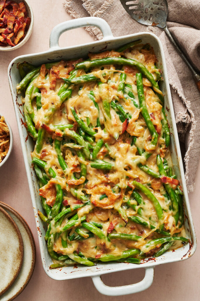 Baked green bean casserole in baking dish on table. 