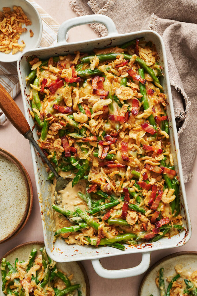 Baking dish with green bean casserole topped with crispy fried onions.