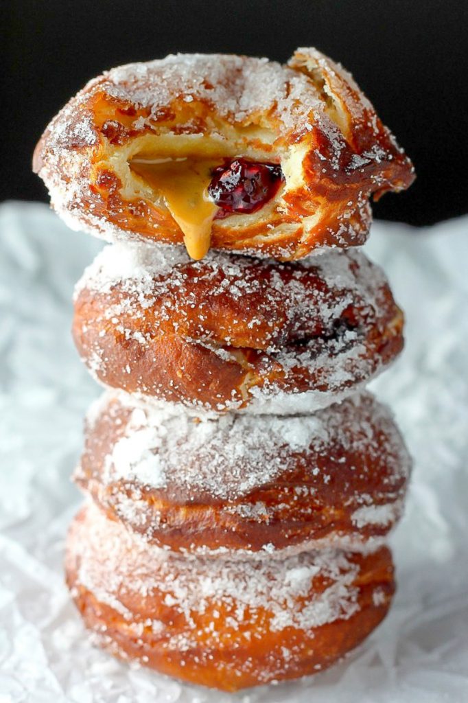 Bakery Style Peanut Butter and Jelly Doughnuts - Soft, fluffy, and stuffed with peanut butter and jelly - these bakery style doughnuts are a classic!