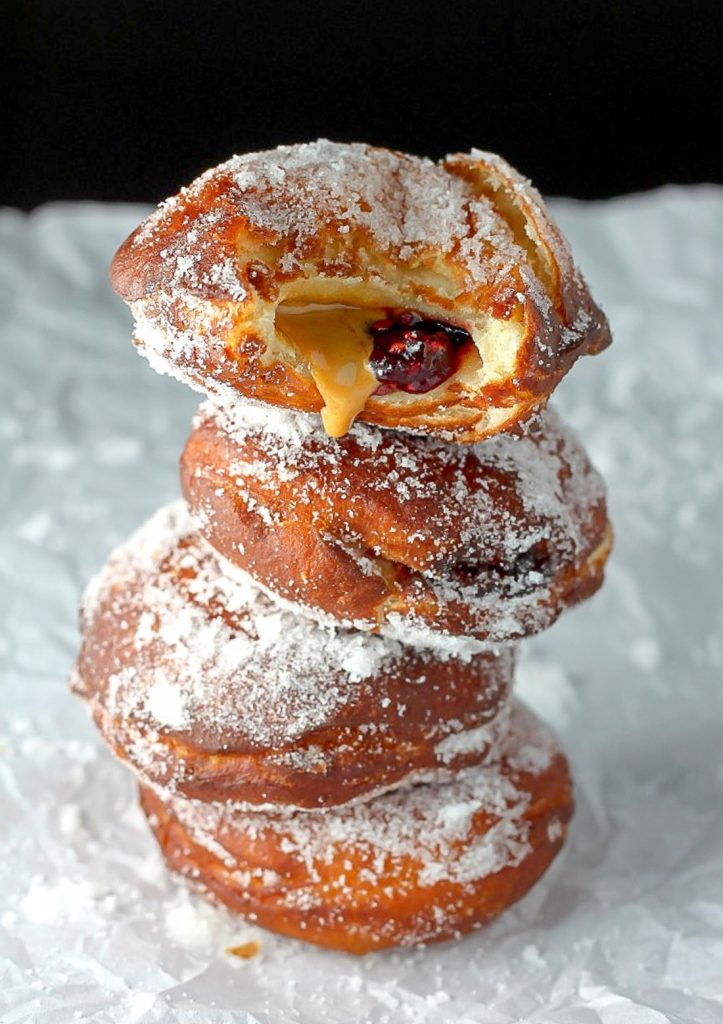 Bakery Style Peanut Butter and Jelly Doughnuts - Soft, fluffy, and stuffed with peanut butter and jelly - these bakery style doughnuts are a classic!