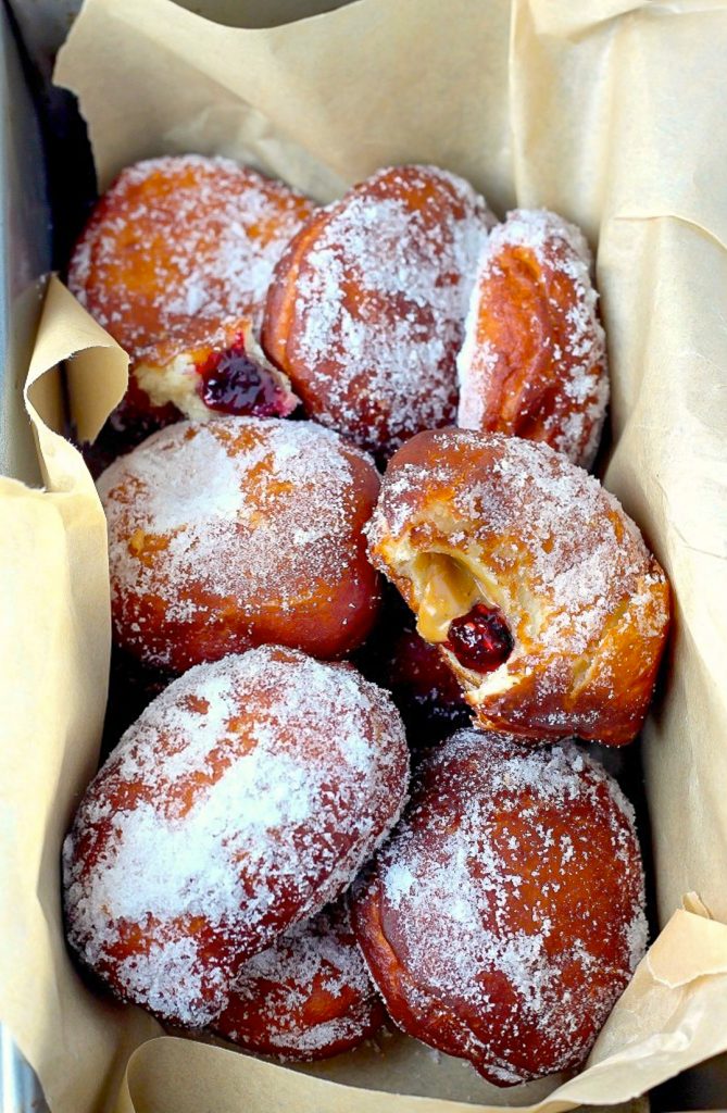 Bakery Style Peanut Butter and Jelly Doughnuts - Soft, fluffy, and stuffed with peanut butter and jelly - these bakery style doughnuts are a classic!