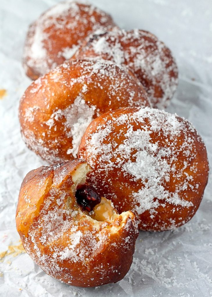 Bakery Style Peanut Butter and Jelly Doughnuts - Soft, fluffy, and stuffed with peanut butter and jelly - these bakery style doughnuts are a classic!