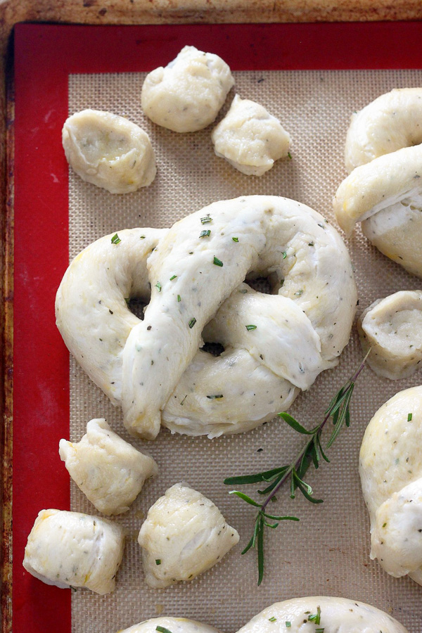 Mozzarella Stuffed Rosemary and Parmesan Soft Pretzels! Made with a simple soft pretzel dough and loaded with fresh herbs and Italian cheese. You're going to love these soft pretzels with cheese inside!