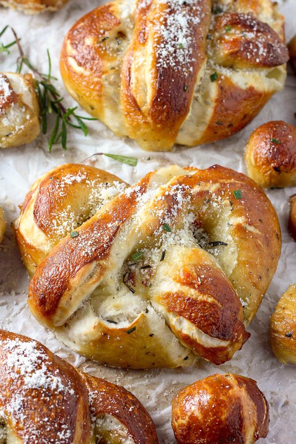 Mozzarella Stuffed Rosemary and Parmesan Soft Pretzels! Made with a simple soft pretzel dough and loaded with fresh herbs and Italian cheese. You're going to love these soft pretzels with cheese inside!