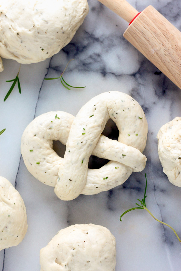 Mozzarella Stuffed Rosemary and Parmesan Soft Pretzels! Made with a simple soft pretzel dough and loaded with fresh herbs and Italian cheese. You're going to love these soft pretzels with cheese inside!