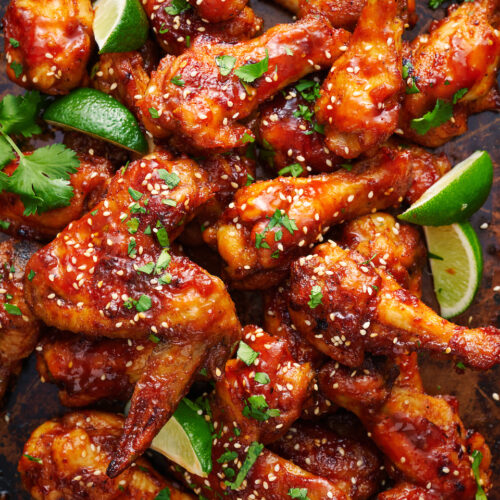 Crispy baked chicken wings on baking sheet.