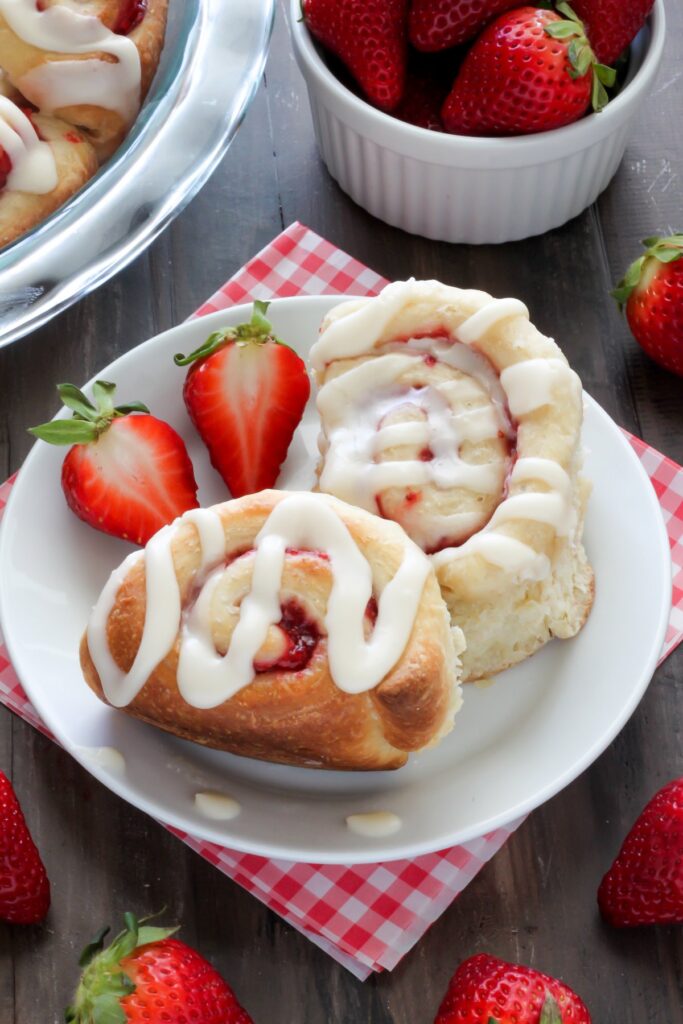Strawberry Rolls with Vanilla Glaze - Soft, fluffy, and swirled with strawberry filling! The vanilla glaze is the perfect finish! 