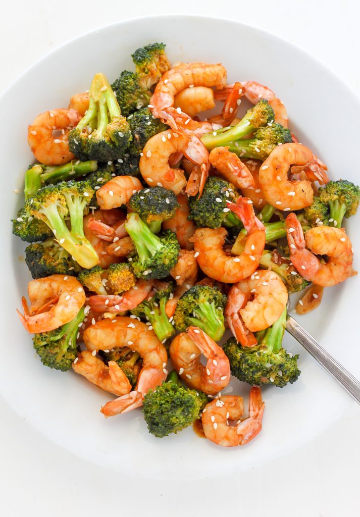 20-Minute Skinny Sriracha Shrimp and Broccoli on a white plate. 