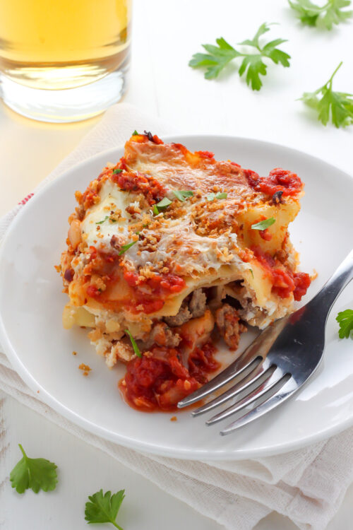 Lightened Up Chicken Parmesan Lasagna - layers of gooey cheese, chicken, sauce, and noodles! THIS IS AMAZING!