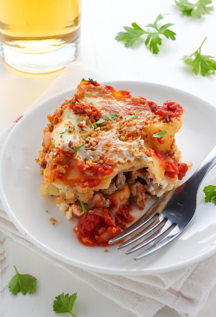 Lightened Up Chicken Parmesan Lasagna - layers of gooey cheese, chicken, sauce, and noodles! THIS IS AMAZING!