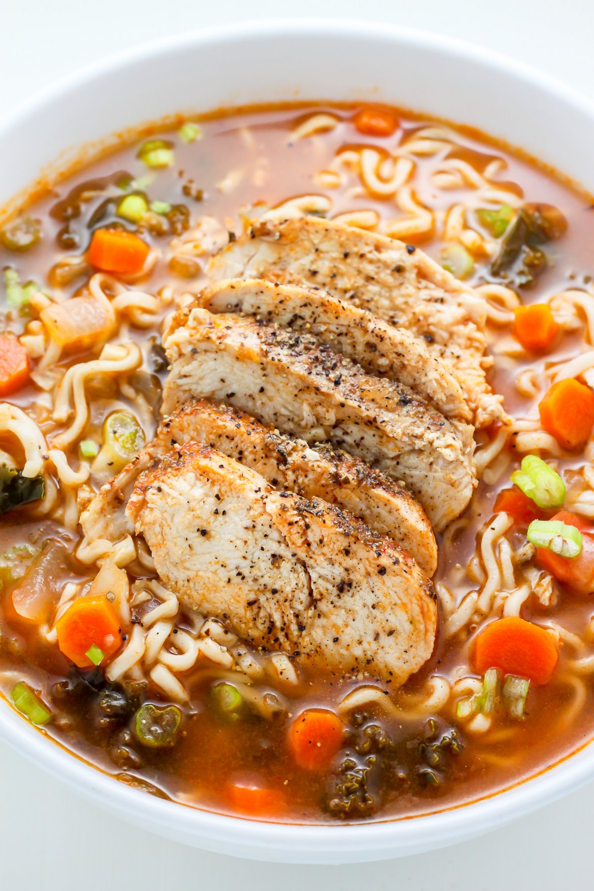 Hearty and Healthy, this Blackened Chicken Ramen Noodle Soup is loaded with carrots, kale, and a TON of flavor! Make this the next time you're craving cozy comfort food - it does the trick every time.