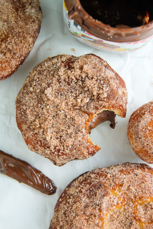 Homemade Cinnamon Sugar Doughnuts stuffed with a dollop of creamy Nutella. The definition of decadence!