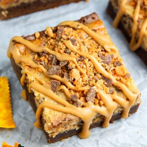 If the thought of Creamy Butterfinger Finger Cheesecake Brownies drizzled with peanut butter glaze makes you weak at the knees, this post is going to rock your life.