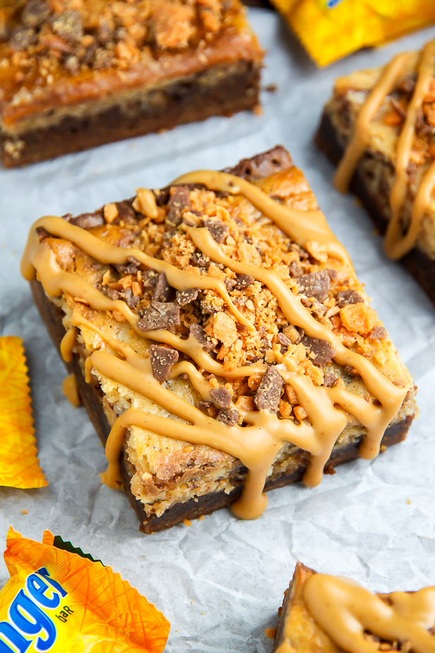 If the thought of Creamy Butterfinger Finger Cheesecake Brownies drizzled with peanut butter glaze makes you weak at the knees, this post is going to rock your life.