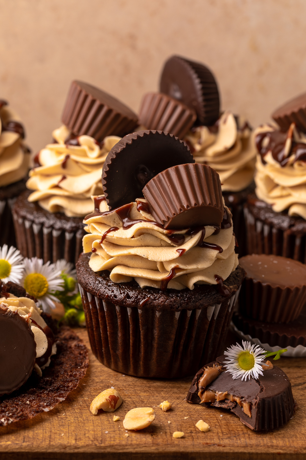 Have a peanut butter lover in your life? You have to bake them these Ultimate Chocolate Peanut Butter Cupcakes!  Featuring moist chocolate cupcakes that are stuffed with a peanut butter cup, topped with peanut butter frosting, milk chocolate peanut butter ganache, and chopped peanuts, these are always a crowd-pleaser!