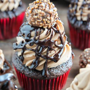 Triple Chocolate Nutella Cupcakes topped with silky chocolate ganache and a chocolate hazelnut truffle.