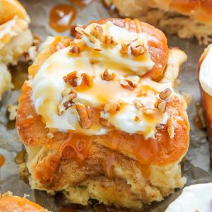 Soft and fluffy homemade cinnamon buns topped with salted caramel and cream cheese frosting!