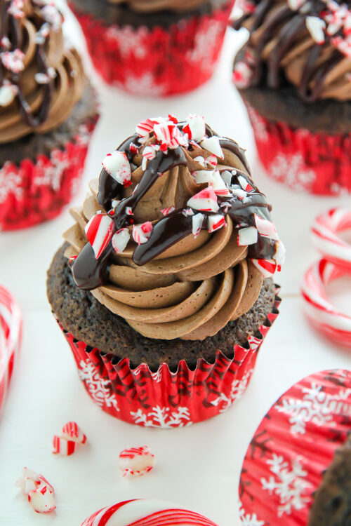Supremely moist and decadent chocolate cupcakes topped with peppermint mocha frosting, a drizzle of chocolate ganache, and crushed candy canes.