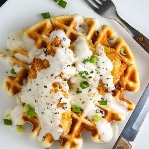 Fluffy buttermilk waffles topped with crispy "oven-fried" chicken and creamy white pepper gravy. Brunch perfection.