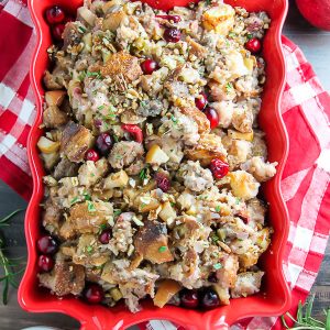 My go-to holiday stuffing recipe loaded with fresh herbs, chopped apples, cranberries, and sausage! Bonus: This recipe can be made ahead to help you save time.