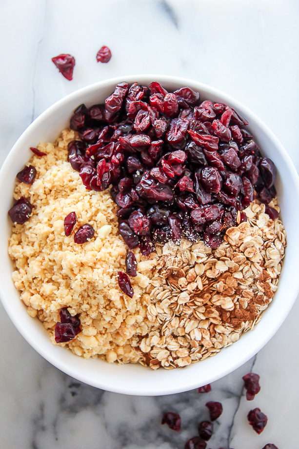 Loaded with cranberries, macadamia nuts, and topped with a sweet drizzle of white chocolate. These homemade granola bars are as easy as they are irresistible!