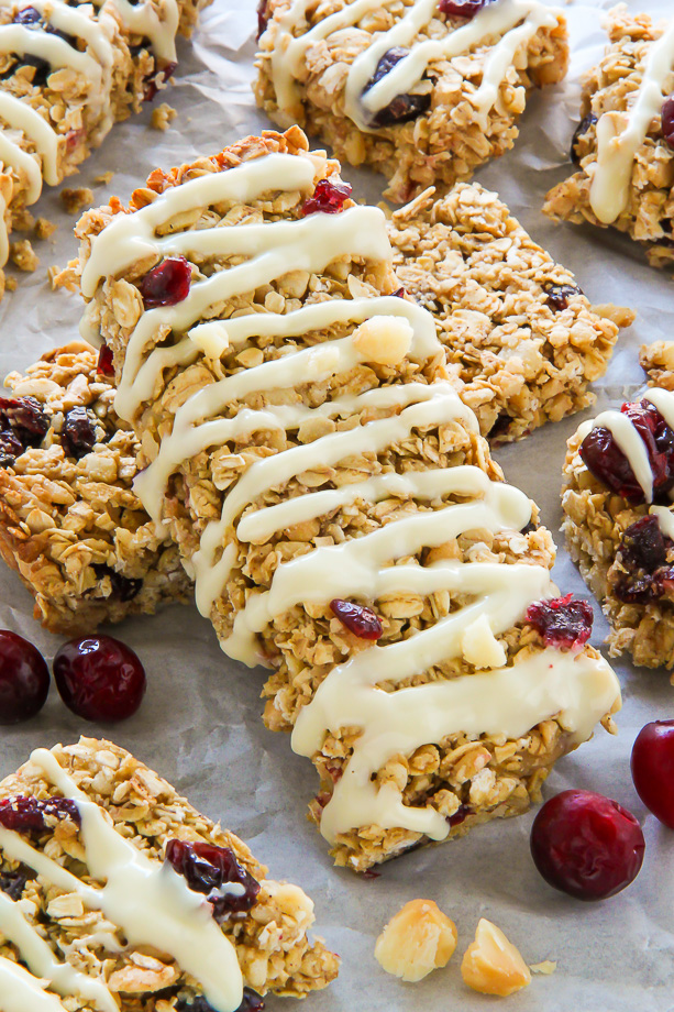 Loaded with cranberries, macadamia nuts, and topped with a sweet drizzle of white chocolate. These homemade granola bars are as easy as they are irresistible!